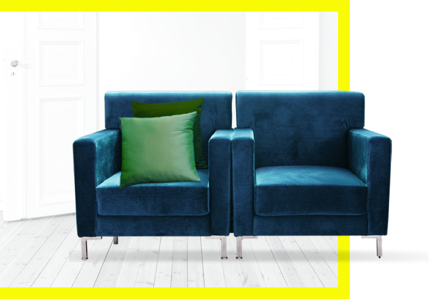 Two navy blue single seat couches side by side with a green couch pillow.